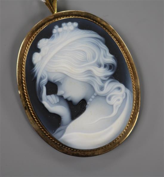 A yellow metal mounted sardonyx cameo pendant brooch, carved with the bust of a young lady to dexter, 50mm.